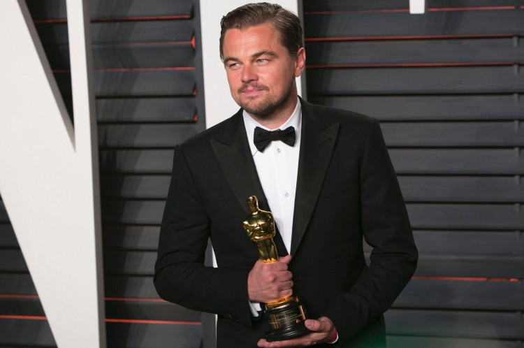 Leo clutching (finally) his own Oscar won last year